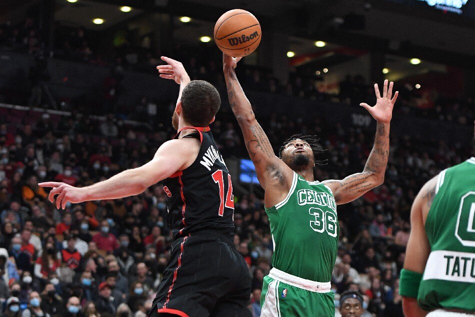 Boston Celtics guard Marcus Smart (36) contests a rebound with Toronto Raptors guard Svi Mykhailiuk (14) in the first half at Scotiabank Arena. Dan Hamilton, USA TODAY Sports/Reuters.