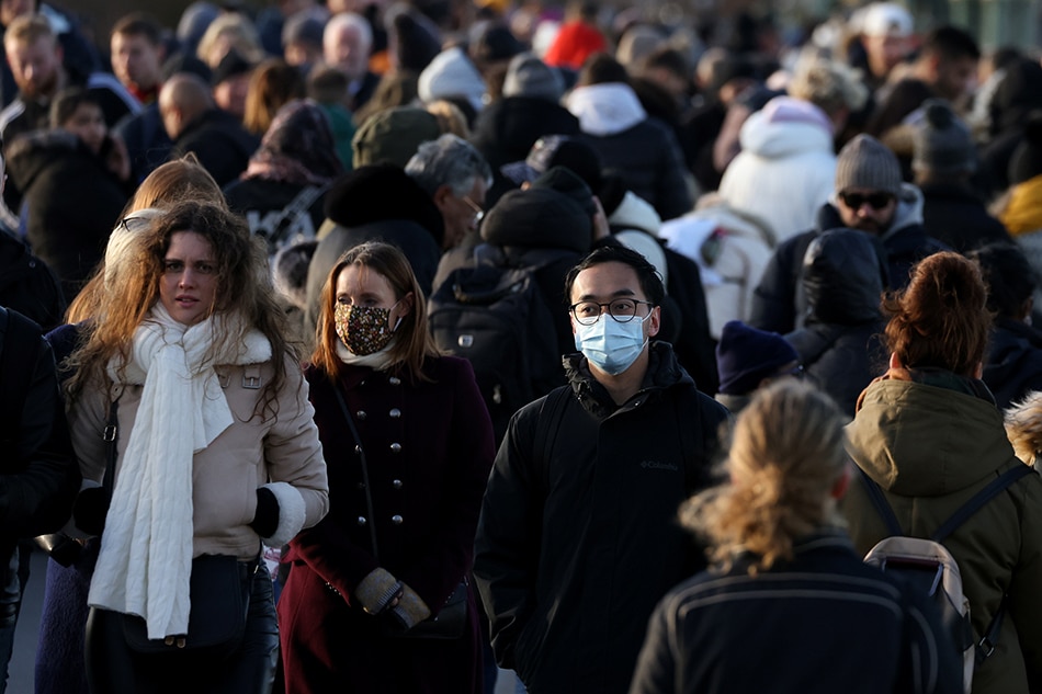 People walk across Westminster Bridge after new measures were announced yesterday due to the Omicron coronavirus variant, in London, Britain, November 28, 2021. Tom Nicholson, Reuters
