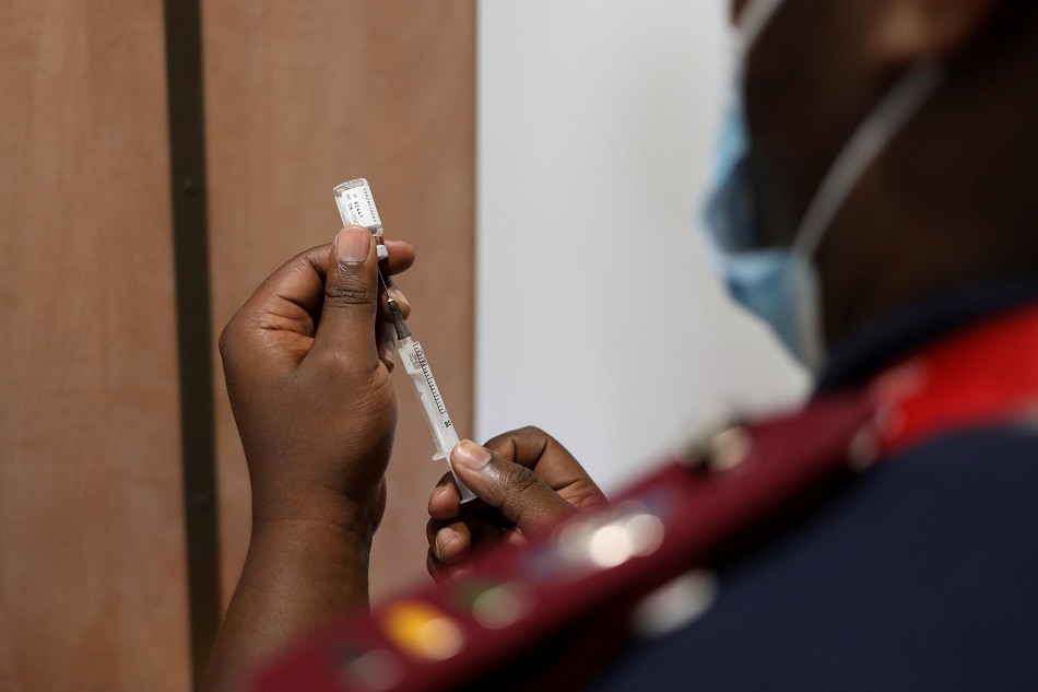 A nurse prepares a dose of the coronavirus disease vaccine as the new Omicron variant spreads, in Dutywa, South Africa November 29, 2021. Siphiwe Sibeko, Reuters/file