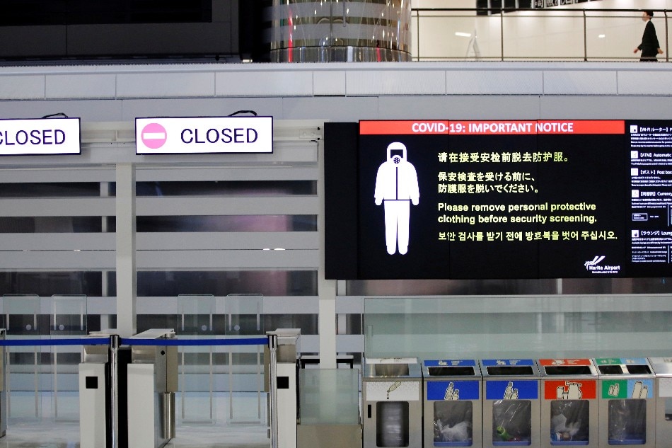 A notice about COVID-19 safety measures is pictured next to closed doors at a departure hall of Narita international airport on the first day of closed borders to prevent the spread of the new coronavirus Omicron variant in Narita, east of Tokyo, Japan, November 30, 2021. Kim Kyung-Hoon, Reuters/File Photo