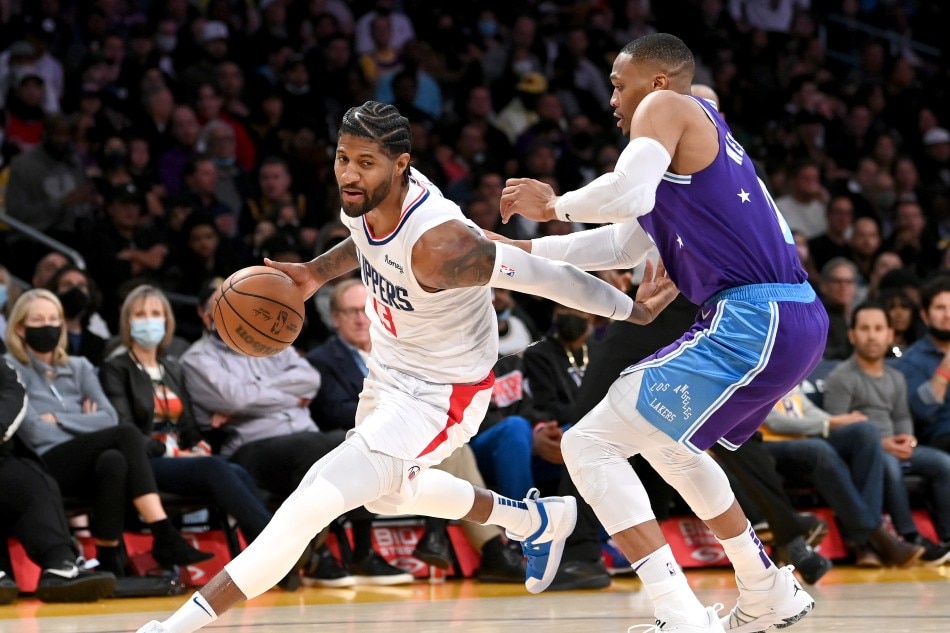 Los Angeles Clippers guard Paul George (13) is defended by Los Angeles Lakers guard Russell Westbrook (0) in the second half at Staples Center. Jayne Kamin-Oncea, USA TODAY Sports via Reuters