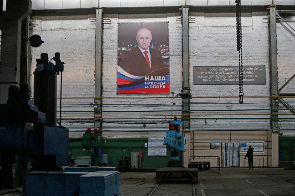 A portrait of Russian President Vladimir Putin is on display at a machine-building plant in the rebel-controlled town of Yasynuvata (Yasinovataya) in the Donetsk region, Ukraine November 21, 2021. An inscription on the portrait reads: 