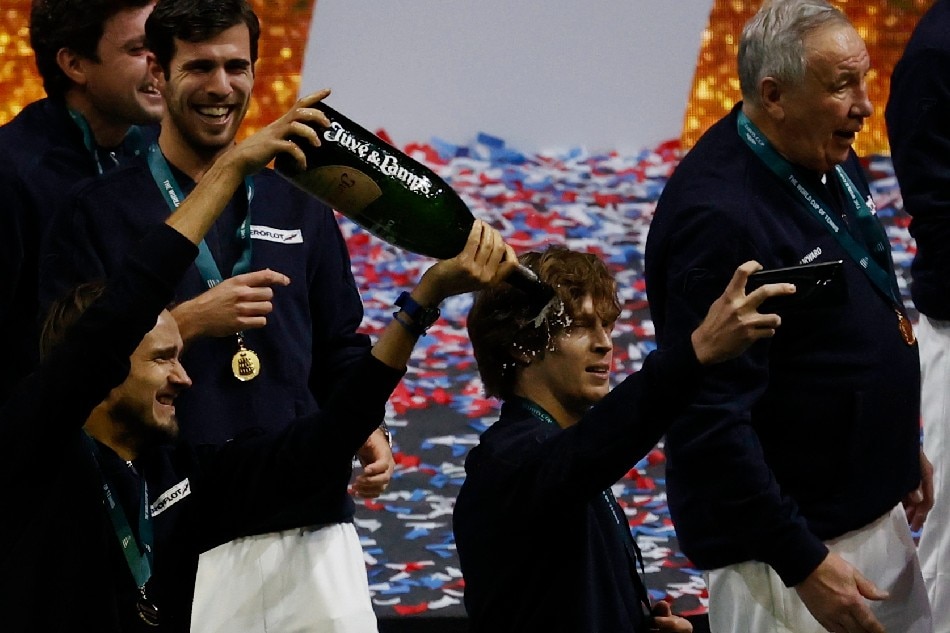 Russian Tennis Federation's Daniil Medvedev celebrates with teammates on the podium after winning the Davis Cup. Susana Vera, Reuters
