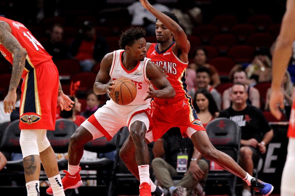 Houston Rockets forward Jae'Sean Tate (8, left) handles the ball while New Orleans Pelicans guard Devonte' Graham (4) defends during the first quarter at Toyota Center. Erik Williams, USA TODAY Sports/Reuters
