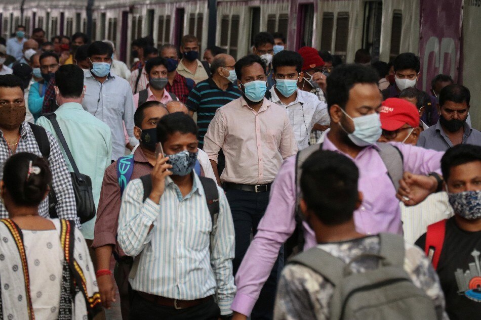 People wearing protective masks walk on a platform at the Chhatrapati Shivaji Terminus railway station, amidst the spread of the coronavirus disease (COVID-19), in Mumbai, India, November 29, 2021. Niharika Kulkarni, Reuters