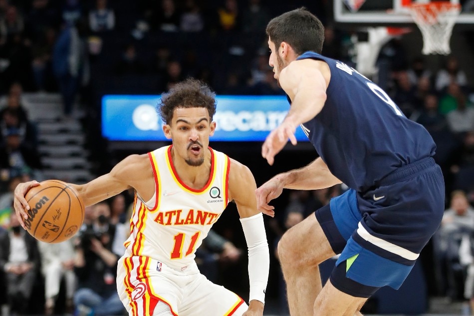 Atlanta Hawks guard Trae Young (11) brings the ball around Minnesota Timberwolves guard Leandro Bolmaro (9) in the first quarter at Target Center. Bruce Kluckhohn, USA TODAY Sports/Reuters.