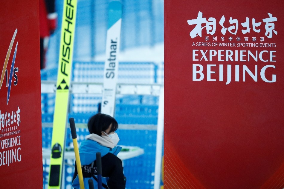  A staff member stands near a sign during the men's nordic combined ski jumping test event at the National Ski Jumping Centre in Zhangjiakou, Hebei, China. Tingshu Wang, Reuters.