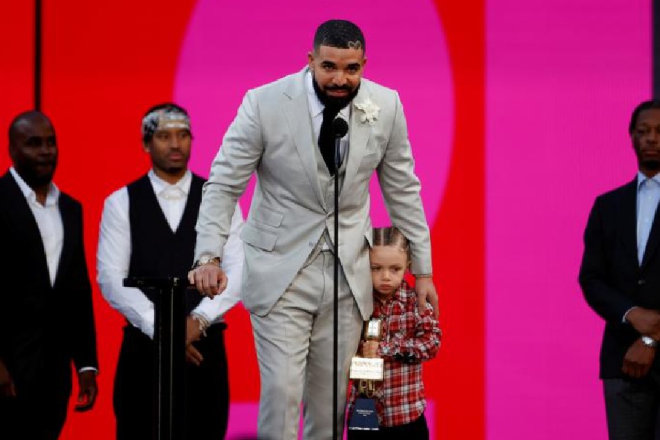 FILE PHOTO: Drake, accompanied by his son Adonis, accepts the award for Artist of the Decade at the 2021 Billboard Music Awards outside the Microsoft Theater in Los Angeles, California, U.S., May 23, 2021. REUTERS/Mario Anzuoni