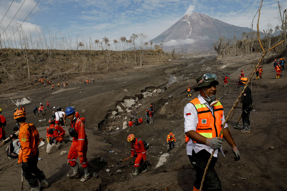  Rescue workers walk at an area affected by the eruption of Mount Semeru volcano during an operation in Curah Kobokan, Pronojiwo district, Lumajang, East Java province, Indonesia, December 8, 2021. Willy Kurniawan, Reuters