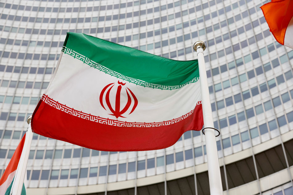 The Iranian flag waves in front of the International Atomic Energy Agency (IAEA) headquarters in Vienna, Austria May 23, 2021. Leonhard Foeger, Reuters/File