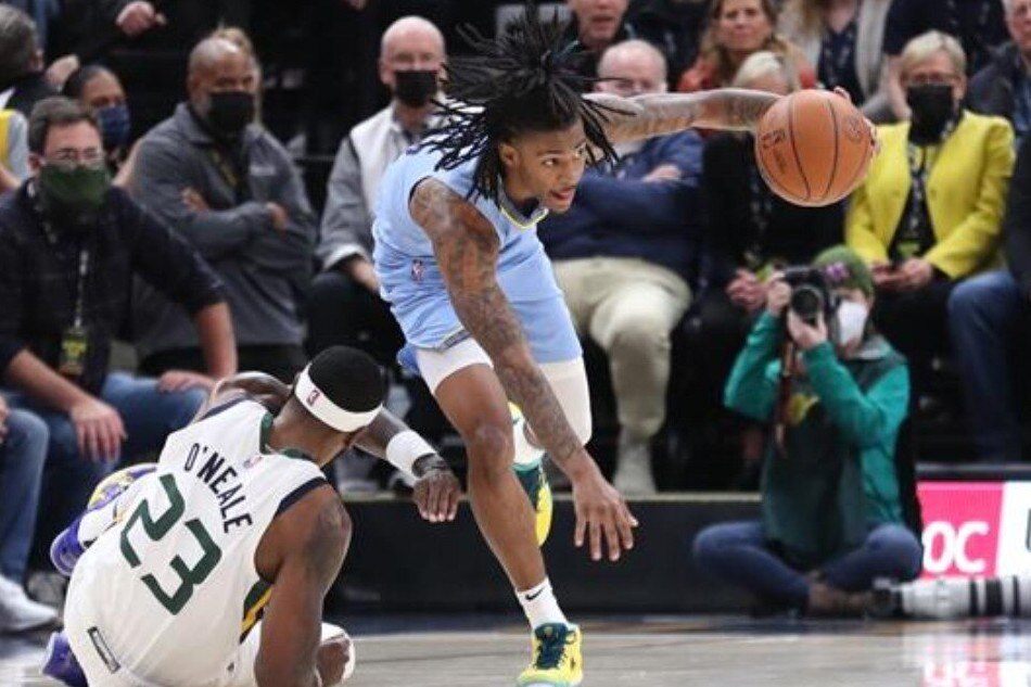Grizzlies guard Ja Morant (12) steals the ball from Utah forward Royce O'Neale in their game on November 22, 2021. Rob Gray, USA TODAY Sports/Reuters