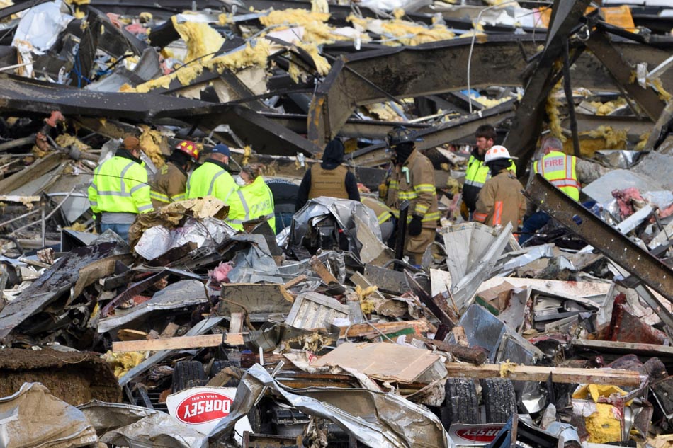 Emergency workers search through what is left of the Mayfield Consumer Products Candle Factory after it was destroyed by a tornado in Mayfield, Kentucky, on Saturday. AFP