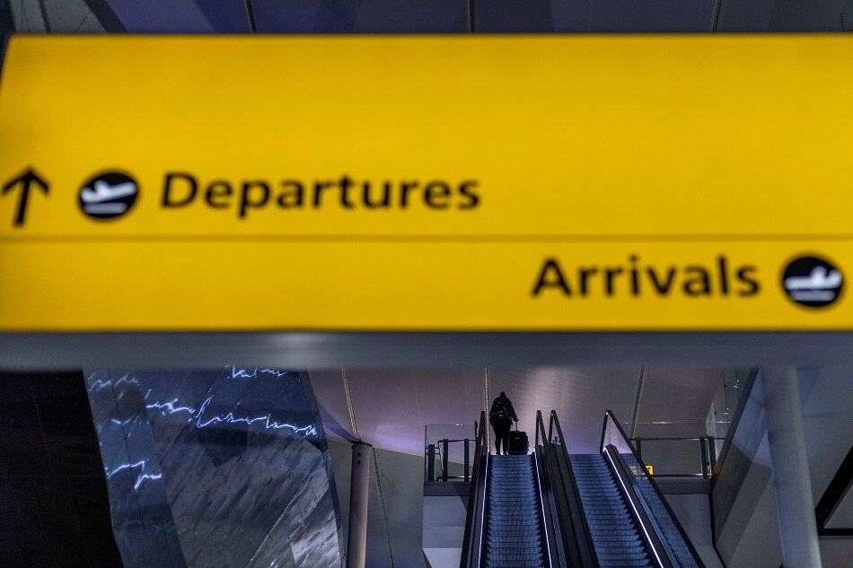 A passenger arrives at terminal 2 of Heathrow International airport ahead of the lifting of restrictions on the entry of non-US citizens imposed to help curb the spread of the coronavirus disease in London on November 7, 2021. Picture taken November 7, 2021. Carlos Barria, Reuters/file
