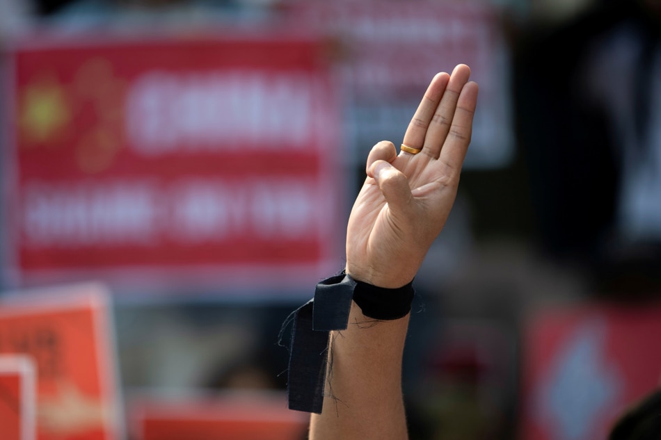 A demonstrator shows the three-finger salute during a protest against the military coup in Yangon, Myanmar, February 21, 2021. Reuters/file 
