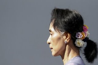 Suu Kyi appears in prison uniform in court