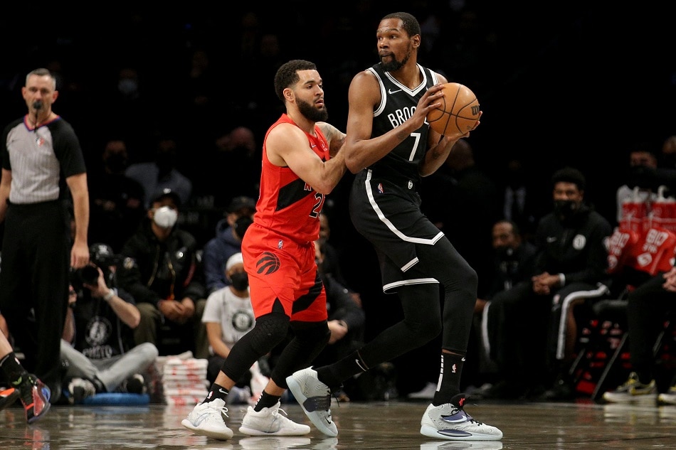 Nets forward Kevin Durant controls the ball against Toronto guard Fred VanVleet in their game on December 4, 2021. Brad Penner, USA Today Sports/Reuters