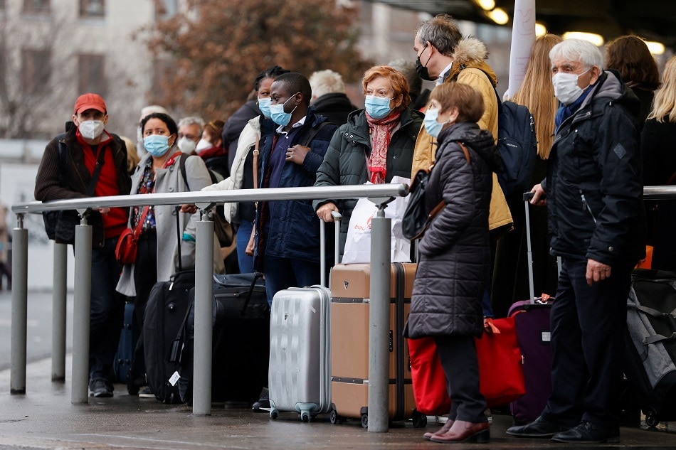 People wait for a taxi after arriving ahead of Christmas at Paris Gare de Lyon railway station, amid the spread of the coronavirus disease pandemic, in Paris, December 24, 2021. Christian Hartmann, Reuters
