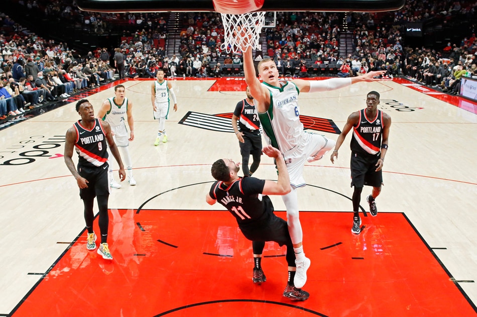 Dallas Mavericks center Kristaps Porzingis (6) is fouled while shooting by Portland Trail Blazers power forward Larry Nance Jr. (11) during the first half at Moda Center. Soobum Im, USA TODAY Sports/Reuters.