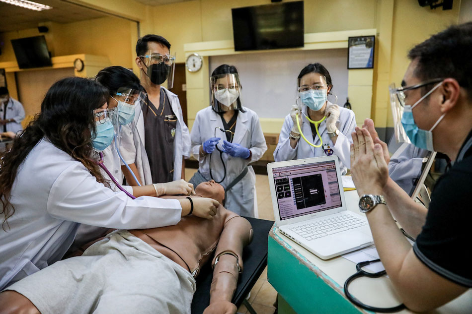 Medical students perform a clinical skills exercise on an electronic dummy during a face-to-face class at the University of Santo Tomas in Manila, on June 10, 2021. Basilio H. Sepe, ABS-CBN News