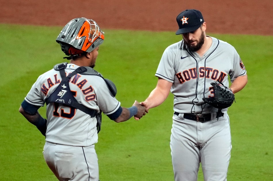Houston Astros catcher Martin Maldonado (15) congratulates relief pitcher Kendall Graveman (31) after defeating the Atlanta Braves in game five of the 2021 World Series at Truist Park. Dale Zanine, USA TODAY Sports/Reuters.