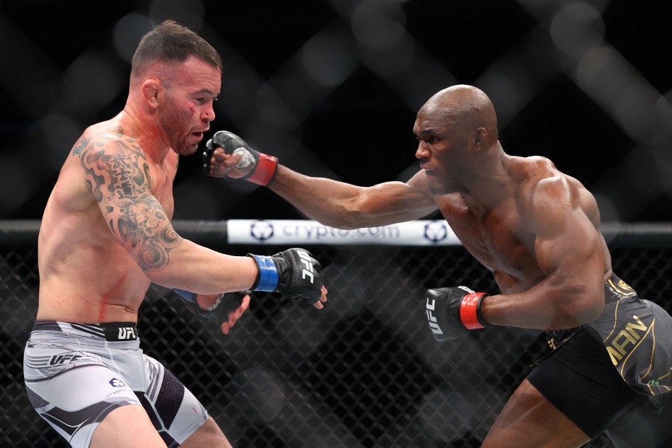 Kamaru Usman (red gloves) competes against Colby Covington (blue gloves) during UFC 268 at Madison Square Garden. Ed Mulholland, USA TODAY Sports/Reuters.