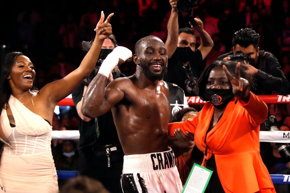 WBO champion Terence Crawford dances with his mother Debra Crawford (R) and other family members after defeating Shawn Porter in a welterweight title fight at Michelob ULTRA Arena on November 20, 2021 in Las Vegas, Nevada. Crawford retained his title with a 10th-round TKO. Steve Marcus, Getty Images/AFP