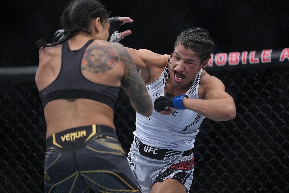 Julianna Pena moves in with a hit against Amanda Nunes during UFC 269 at T-Mobile Arena. Stephen R. Sylvanie, USA TODAY Sports/Reuters.