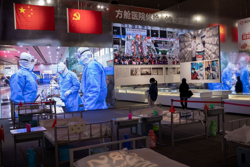 People visit an exhibition about Chinaí fight against the COVID-19 at a convention center that was previously a makeshift hospital for coronavirus patients in Wuhan on January 15, 2021. Nicolas Asfouri, AFP