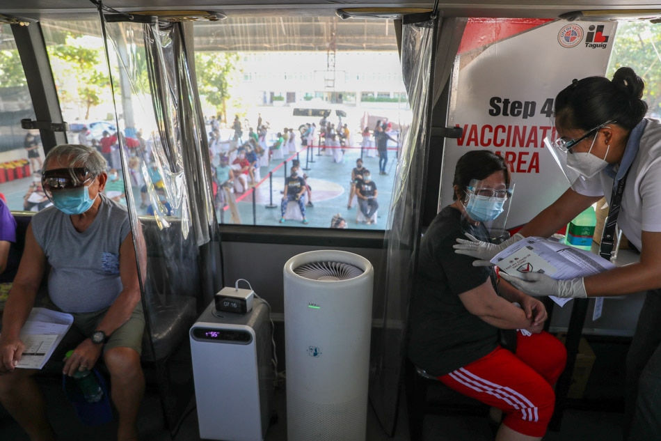 Taguig residents get COVID-19 jabs in mobile vaccination bus