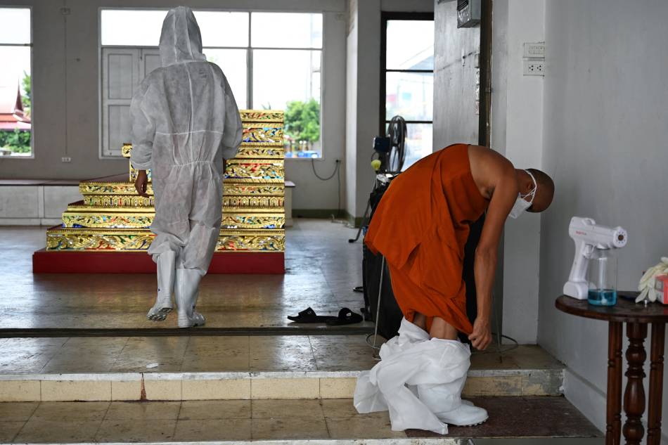 Thai monks don protective gear as COVID cases surge 1