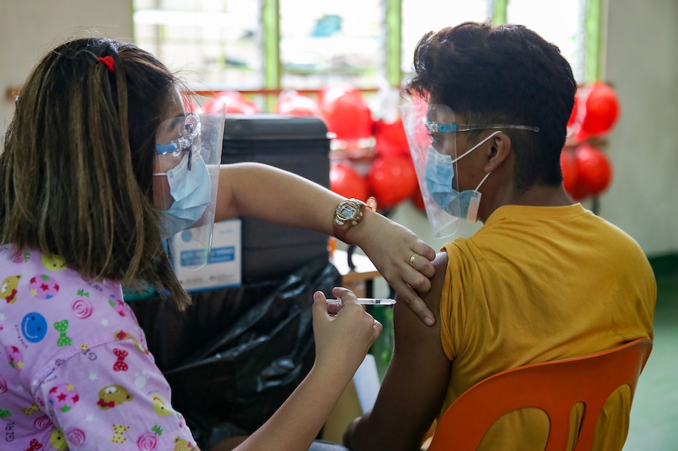 Manila residents belonging to categories A1, A2, A3, and A4 priority group get their vaccine jabs against COVID-19 inside the President Sergio Osmeña Highschool in Tondo, Manila on June 9, 2021. George Calvelo, ABS-CBN News