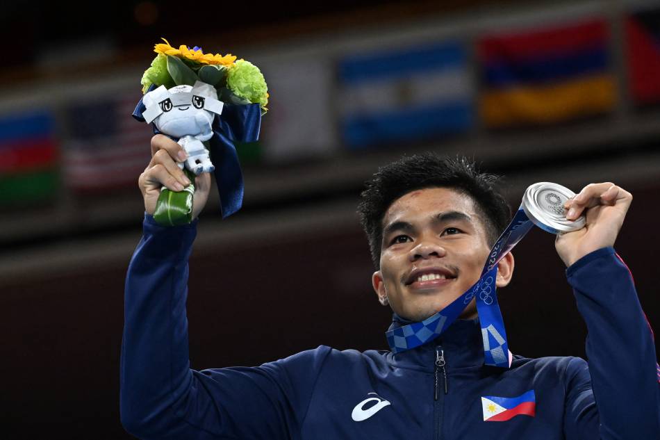 Philippines' Carlo Paalam celebrates his silver medal during the medal ceremony for the men's fly (48-52kg) boxing final bout during the Tokyo 2020 Olympic Games at the Kokugikan Arena in Tokyo on August 7, 2021. Luis Robayo, AFP