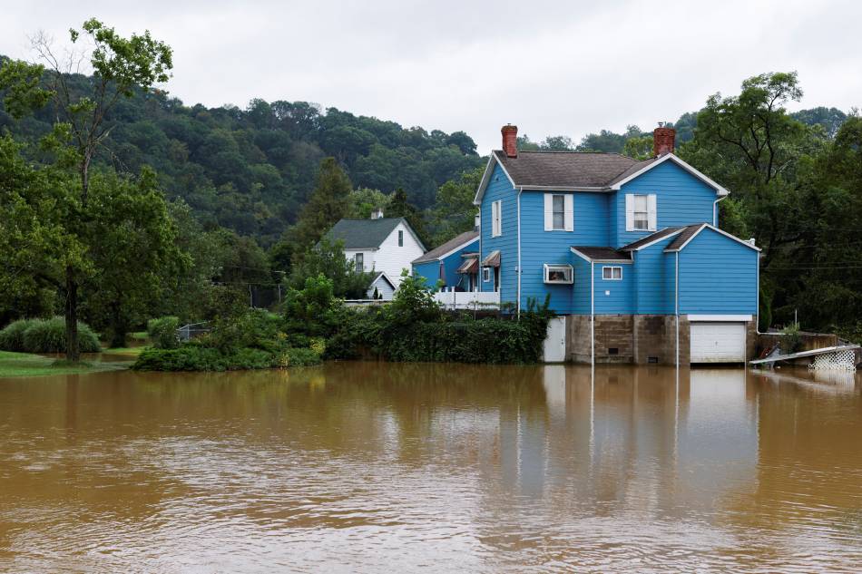 A house sits safely above flood waters as heavy rains from storm Ida causes flooding in Glenshaw, Pennsylvania, U.S., September 1, 2021. Quinn Glabicki, Reuters