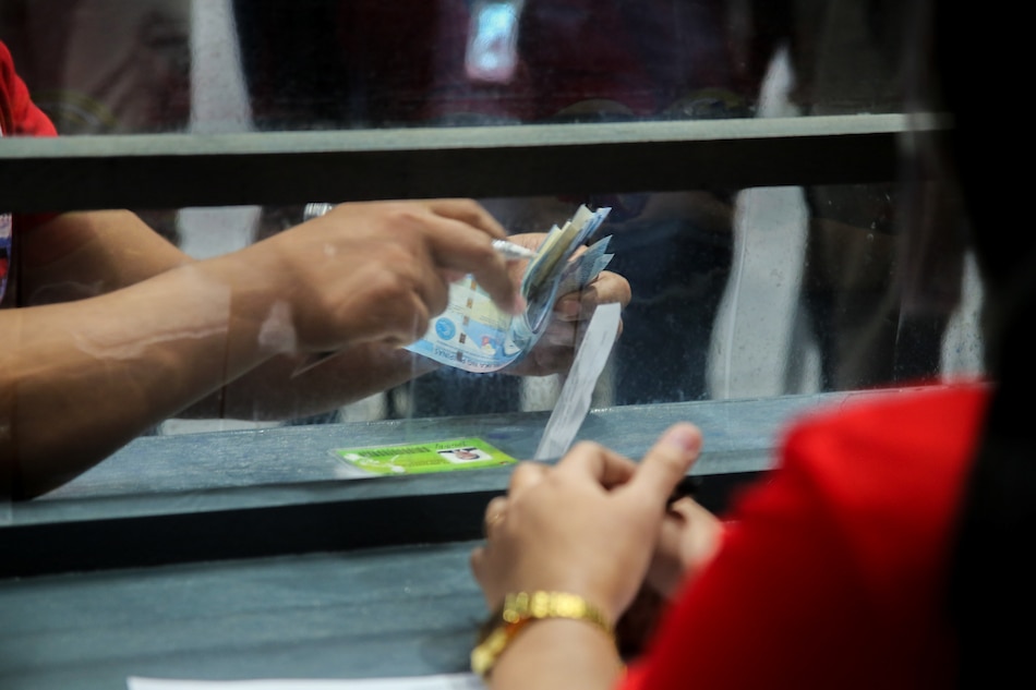 Frontline workers from San Juan receive cash at the FilOil Flying V Center in San Juan City on Aug. 27, 2021 during the distribution of financial assistance to medical and non-medical personnel involved in the COVID-19 response. Jonathan Cellona, ABS-CBN News/File 
