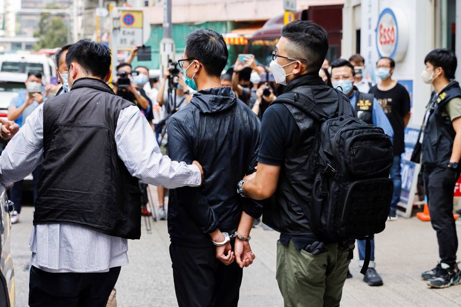 Leung Kam-wai, one of the arrested members of the Hong Kong Alliance in Support of Patriotic Democratic Movements of China is escorted by police as they leave after police search the June 4th Museum, which commemorates the 1989 Tiananmen Square crackdown, in Hong Kong on September 9, 2021. Tyrone Siu, Reuters