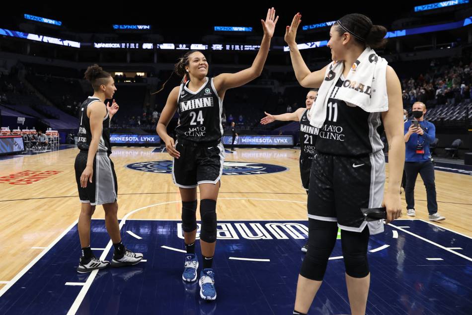 Napheesa Collier #24 of the Minnesota Lynx high-fives teammate Natalie Achonwa #11 after the game against the Connecticut Sun on May 30, 2021 at Target Center in Minneapolis, Minnesota. File photo. David Sherman, NBAE via Getty Images/AFP.