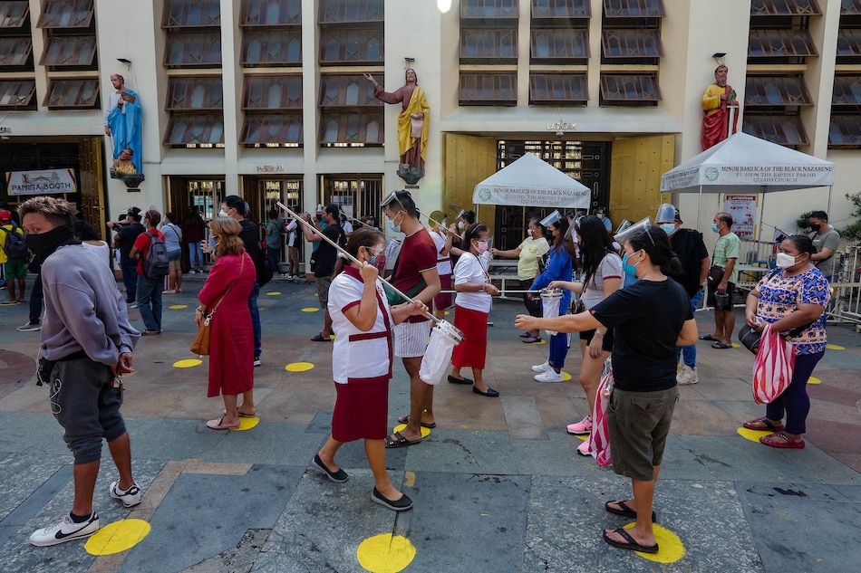 Catholic devotees pray outside the Quiapo Church in Manila on the first day of the implementation of COVID-19 Alert Level 4 in NCR on Sept. 16, 2021. George Calvelo, ABS-CBN News/File