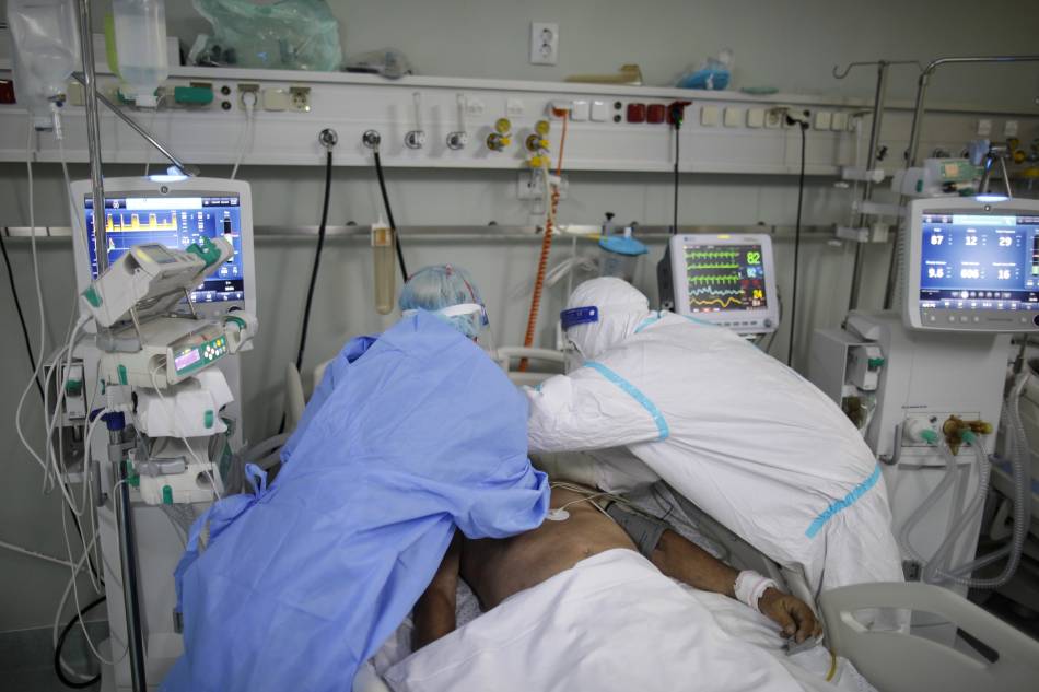 An intensive care unit (ICU) doctor and nurse, wearing Personal Protective Equipment (PPE) assist a coronavirus disease (COVID-19) patient at Marius Nasta Institute of Pneumology in Bucharest, Romania, on September 22, 2021. Inquam Photos/Octav Ganea via Reuters