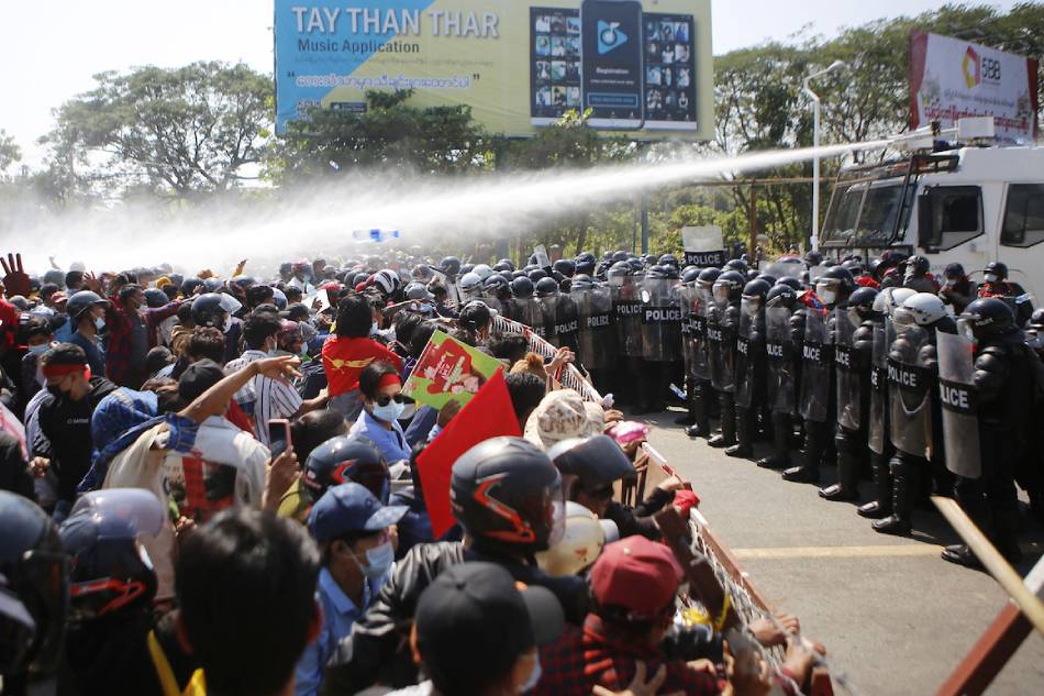 Police fire water cannons at protesters as they continue to demonstrate against the February 1 military coup in the capital Naypyidaw on February 9, 2021 in Myanmar. Agence France-Presse