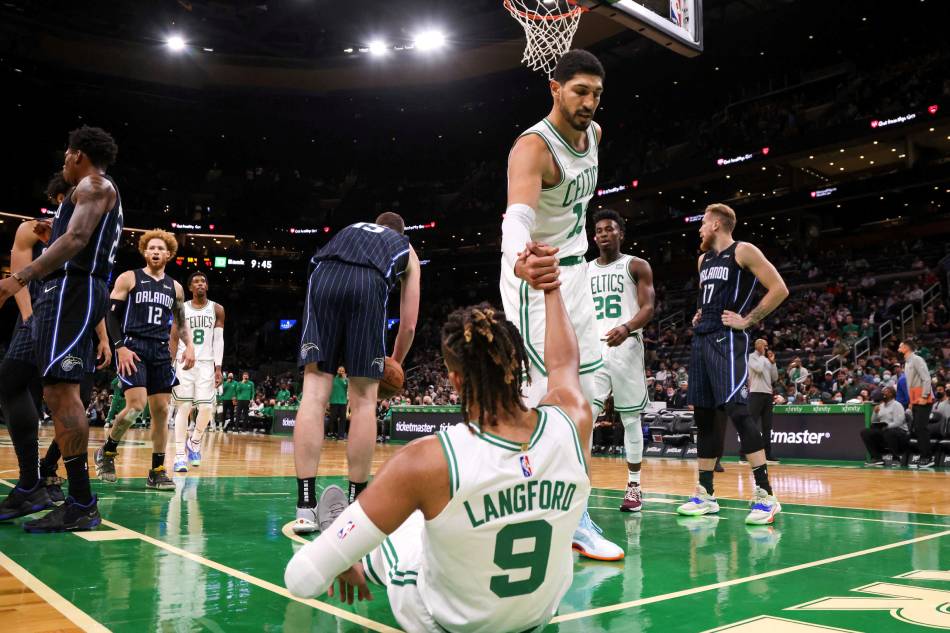 Boston Celtics center Enes Kanter (13) helps up guard Romeo Langford (9) during the second half against the Orlando Magic at TD Garden. Mandatory Credit: Paul Rutherford, USA TODAY Sports/via Reuters