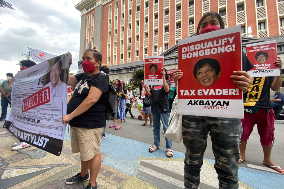 Members of Akbayan Partylist held a protest action outside the Commission on Election headquarters on Nov. 4, 2021, calling for the disqualification of presidential candidate Ferdinand 