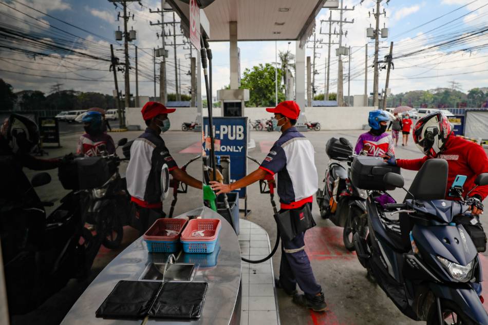 Motorbike riders stop for gas at a refueling station at the Petron Gas station on Commonwealth Avenue in Quezon City on March 02, 2021. Jonathan Cellona, ABS-CBN News/File