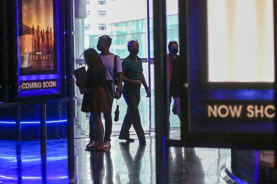 People arrive at the Gateway Cineplex in Gateway Mall in Cubao, Quezon City on November 10, 2021 as it opens its doors to patrons for the first time since the start of various COVID-19 quarantine measures in the capital region. Jonathan Cellona, ABS-CBN News