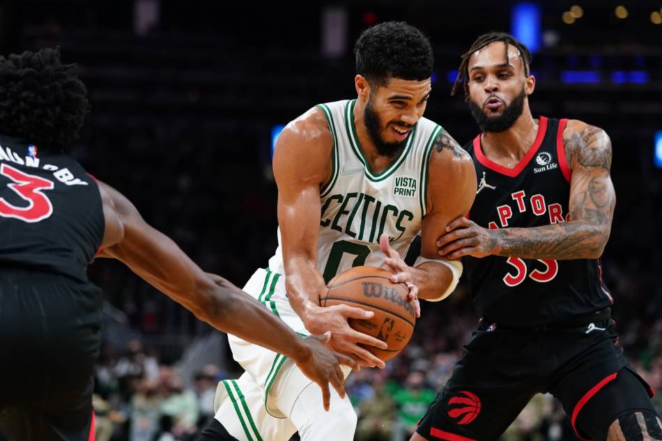 Boston Celtics forward Jayson Tatum (0) drives the ball against Toronto Raptors guard Gary Trent Jr. (33) and forward OG Anunoby (3) in the second half at TD Garden. David Butler II, USA TODAY Sports/Reuters.