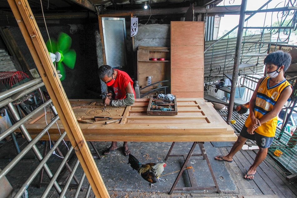 Woodcarver Francis Amoring works on a door at their shop along Commonwealth Avenue in Quezon City on April 29, 2020. Small businesses are seeing hard times due to the COVID-19 pandemic. Jonathan Cellona, ABS-CBN News