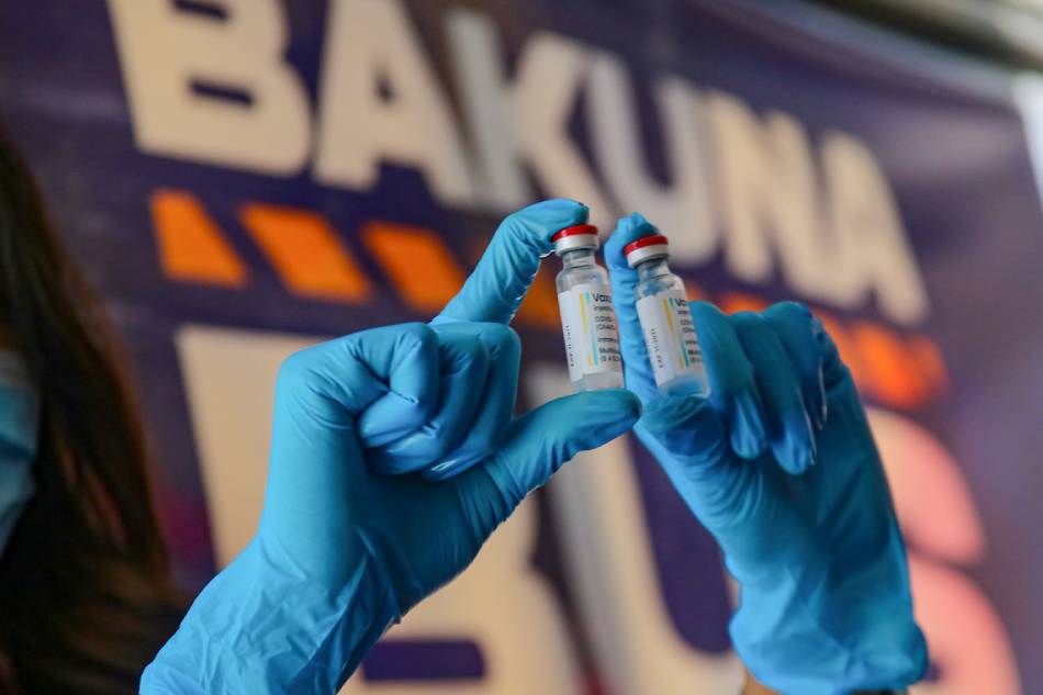 A health worker show vials of the AstraZeneca COVID-19 vaccine at the Bakuna Bus (Vaccine Bus) by the Philippine Red Cross (PRC) in Manila on November 18, 2021. Jonathan Cellona, ABS-CBN News