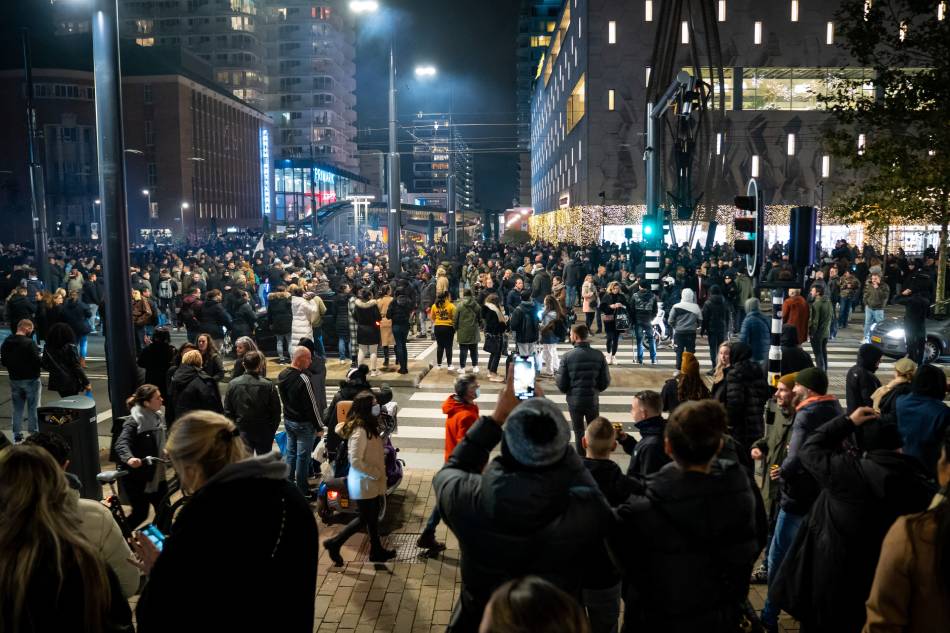 Demonstrators take part in a protest against a partial coronavirus lockdown and against the government policy on Coolsingel street on November 19, 2021 in the port city of Rotterdam. Killian Lindenburg, ANP via AFP