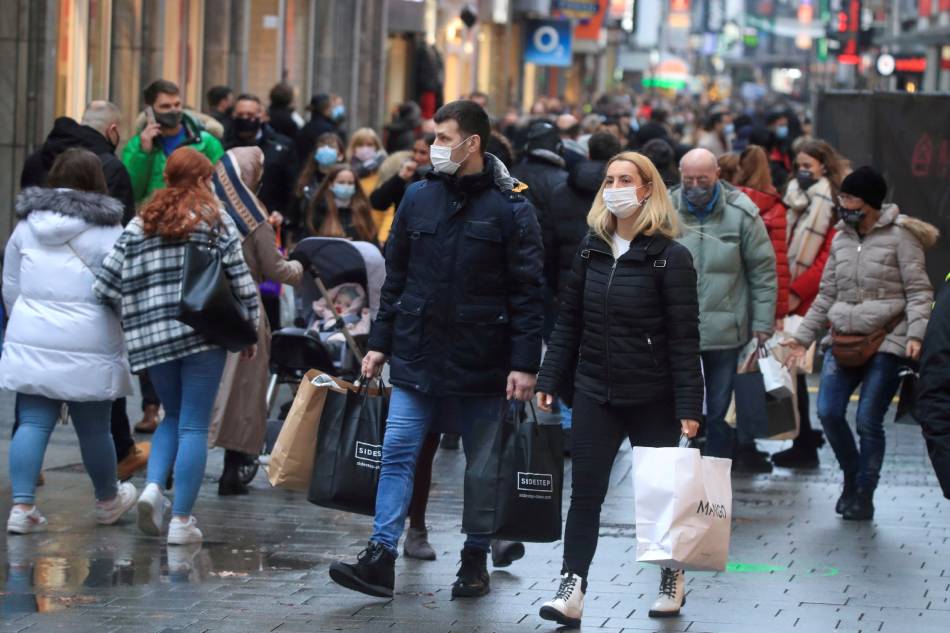 Shoppers fill Cologne's main shopping street Hohe Strasse (High Street) in Cologne, Germany, Dec. 12, 2020. Wolfgang Rattay, Reuters/File