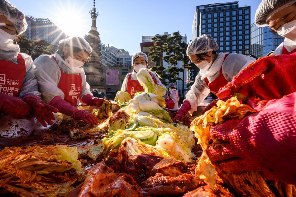 Participants prepare kimchi, a traditional Korean dish of spicy fermented cabbage and radish, during a kimchi making festival at the Jogyesa Buddhist temple in Seoul. Anthony Wallace, AFP 