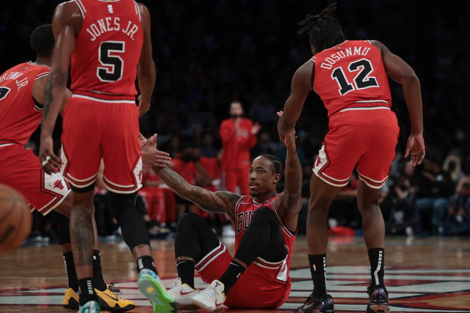 Chicago Bulls forward DeMar DeRozan (11) is help up by teammates aft being fouled during the first half against the Brooklyn Nets at Barclays Center. Vincent Carchietta, USA TODAY Sports/Reuters.